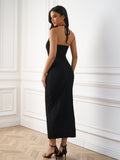 Back view of a black textured knit maxi dress with a halter neckline.