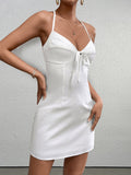 Front detail of a white satin mini dress with a halter neckline and tie front