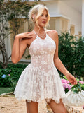 Woman posing in a white floral embroidered halter mini dress