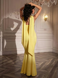 Back view of a woman in a strapless yellow mermaid gown with a scarf accent.
