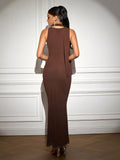Back view of a woman in a brown ribbed knit maxi dress with a halter tie detail