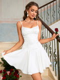 Woman holding a red rose, wearing a white satin dress with lace overlay and a pleated skirt.
