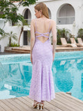 Back view of a lavender lace mermaid dress with criss-cross straps and an open back.