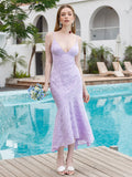 Full-length view of a woman in a lavender lace mermaid dress by a swimming pool.