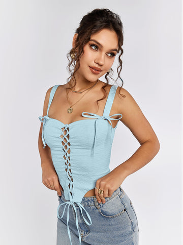 Woman wearing a light blue jacquard lace-up camisole with tie shoulder straps