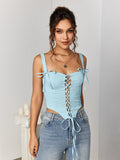 Front view of a woman posing in a light blue jacquard lace-up camisole