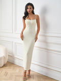Front view of a woman modeling a white textured knit sheath dress with spaghetti straps and a sweetheart neckline.
