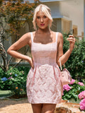 Front view of a woman wearing a pink jacquard rose pattern dress, looking at the camera.