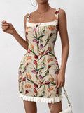 Woman holding a chain strap handbag while wearing a floral print dress