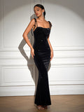 Model posing in a sparkling black velvet mermaid dress