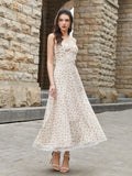 Full body shot of a woman in a cream floral print A-line midi dress