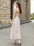 Back view of a woman in a cream floral print midi dress