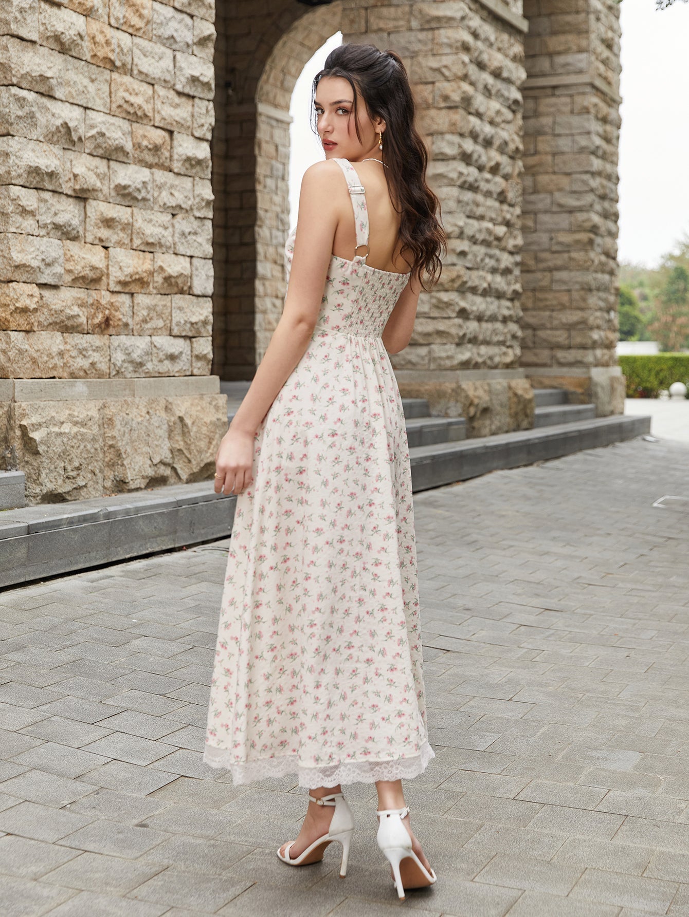 Back view of a woman in a cream floral print midi dress