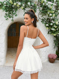 Back view of a woman in a white mini dress with a corset lace-up detail.