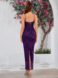 Back view of a woman in a purple and pink floral print maxi dress with a lace-up back detail and a side slit.