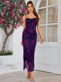 Full-length shot of a woman in a floral print sheath dress with a high side slit.