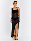 Full front view of a woman in a long black sheer dress with ruffled trim