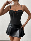 Close-up of the front of the black ribbed knit camisole showing lace trim and tie detail.