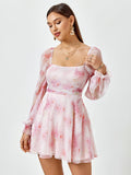 Close-up of a woman in a pink floral print dress, showing the square neckline and long sleeves.