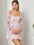 Woman in a pink floral print dress with a square neckline and long sleeves, standing against a textured wall.