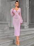 Full body shot of a woman in a pink knit midi dress with cut-out details.