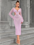 Front view of a woman posing in a pink knit midi dress with cut-out details.