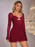 Front view of a woman in a red sparkling mesh mini dress with a cut-out detail and sweetheart neckline.