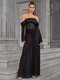Woman wearing a black off-the-shoulder sheer mesh maxi dress with long flared sleeves.