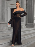 Woman posing in a black off-the-shoulder sheer mesh maxi dress.