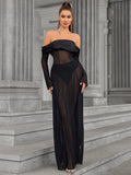 Full-length front view of a woman in a black sheer mesh maxi dress.