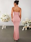 Back view of a woman in a pink strapless ribbed knit mermaid maxi dress