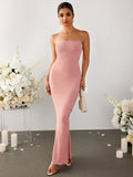 Woman wearing a pink strapless ribbed knit mermaid maxi dress