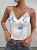 Front view of a woman wearing a white floral print corset top with blue flowers and spaghetti straps.