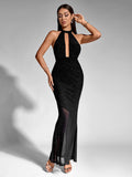 Woman posing in a black sparkling halter neck maxi dress with a keyhole cutout