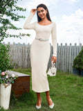 Woman posing in a cream ribbed knit long sleeve midi bodycon dress with a scoop neckline and a light gray belt, holding a white handbag.