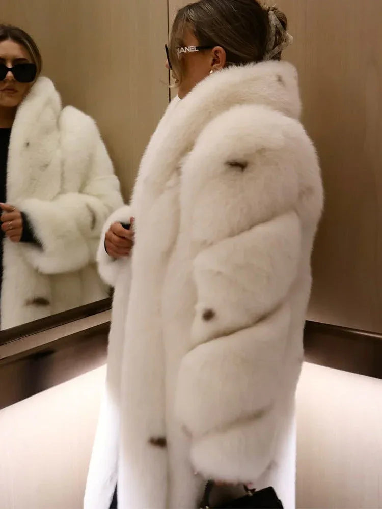 Close-up of a woman in a white faux fur coat, showing texture and buttons.