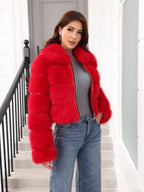 Front view of a woman in a vibrant red faux fur jacket with a collared design and full-length sleeves.