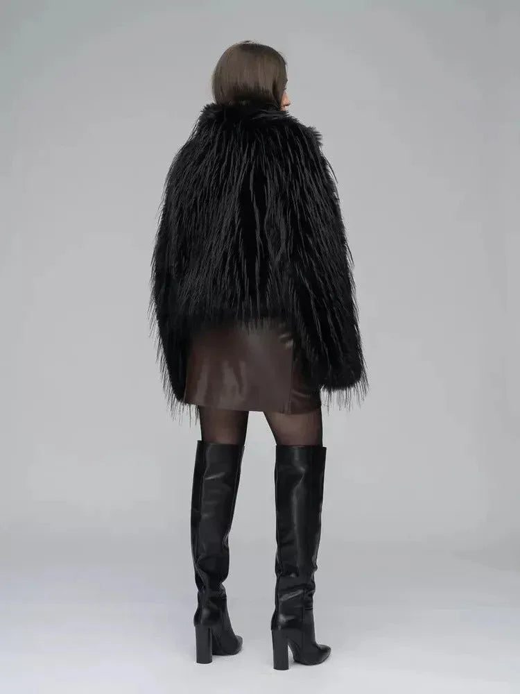 Close-up of a woman wearing a black shaggy faux fur jacket and adjusting her sunglasses