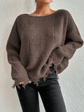 Woman wearing a brown oversized distressed knit sweater with raw hem