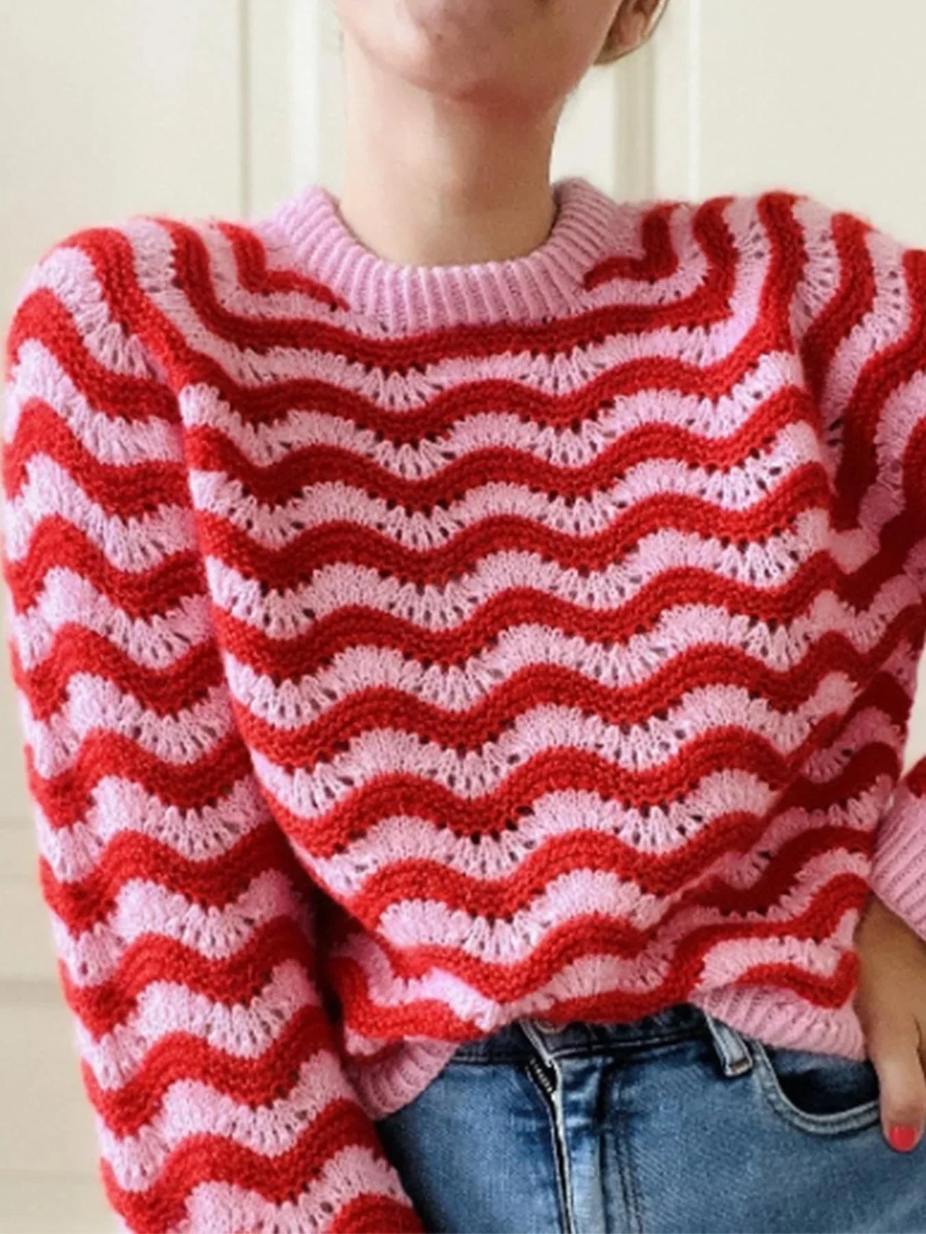 Close-up of a red and pink chevron knit sweater