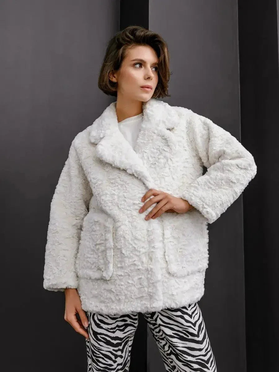Woman wearing a white textured faux fur jacket with notched lapels and two front pockets Main image