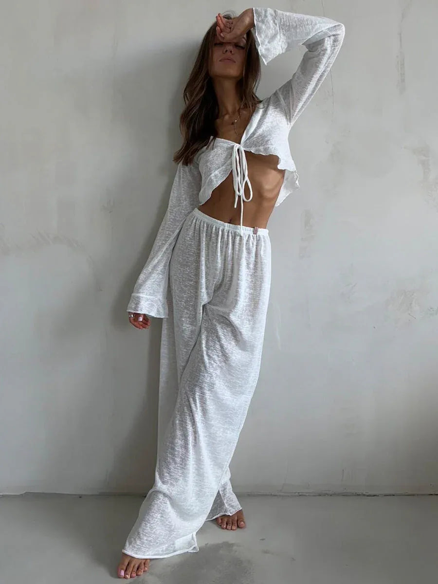Model in a white sheer knit loungewear set, showcasing the bell sleeves and relaxed fit.