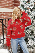 Woman posing in a red holiday sweater with a reindeer pattern
