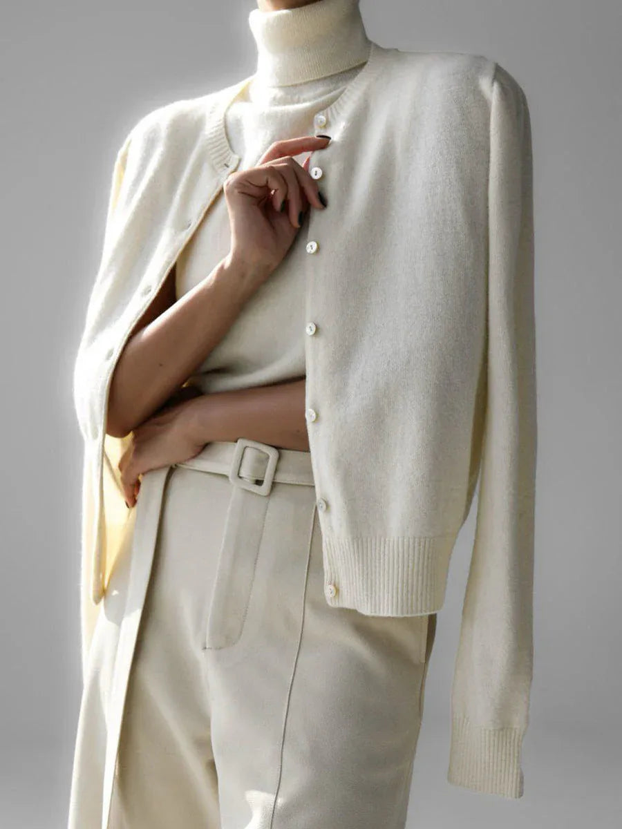 Close-up of a woman wearing a cream-colored fine knit cardigan
