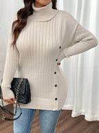 Close-up of a woman wearing a cream ribbed knit turtleneck tunic sweater with side buttons.