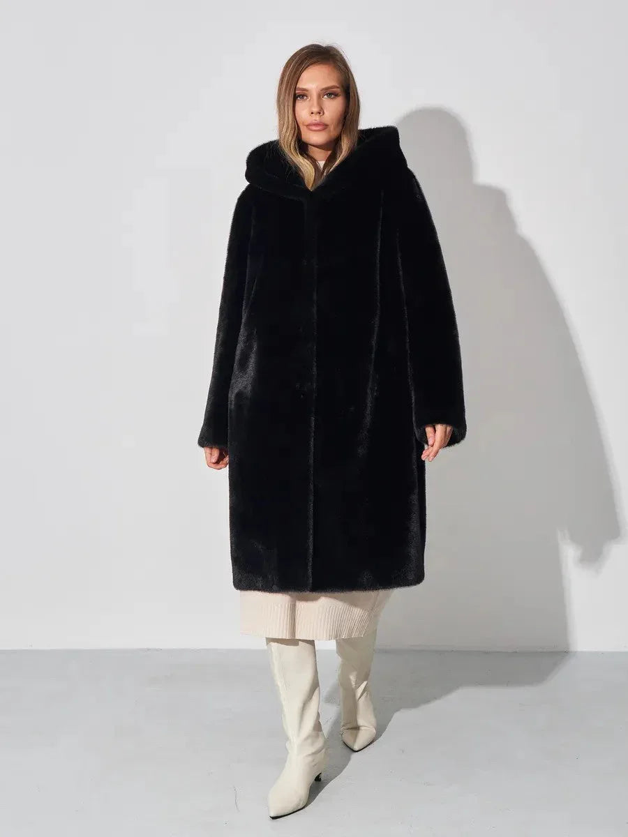 Woman wearing a black hooded faux fur coat