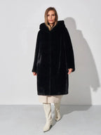 Woman wearing a black hooded faux fur coat