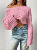 Model showing the off-the-shoulder styling of a white cropped sweater