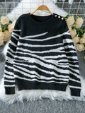 Woman wearing a white and brown zebra print crew neck sweater - View 9 | WEUXS