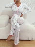 woman sitting on couch wearing white floral print pajama set